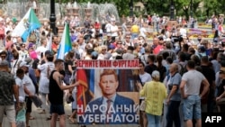 Demonstrators in Khabarovsk, Russia on July 25, 2020 carry a poster that calls for the return of former Governor Sergei Furgal, dubbed "The People's Governor." 