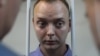 Ivan Safronov, a former journalist who works as an aide to the head of Russia's space agency Roskosmos, stands inside the defendants' cage at a July 7, 2020 court hearing in Moscow on charges of treason.