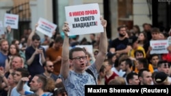 A protester during July 2019 rallies in Moscow for the registration of opposition and independent candidates for city council holds a poster that reads "I have the right to my own candidate!" 