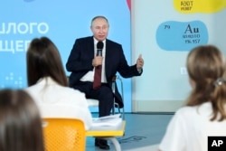 Russian President Vladimir Putin meets with schoolchildren in Vladivostok on the first day of school, September 1, 2021.
