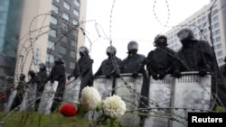 Belarusian law enforcement officers stand guard during a rally in Minsk to reject Belarus' official 2020 presidential election results.