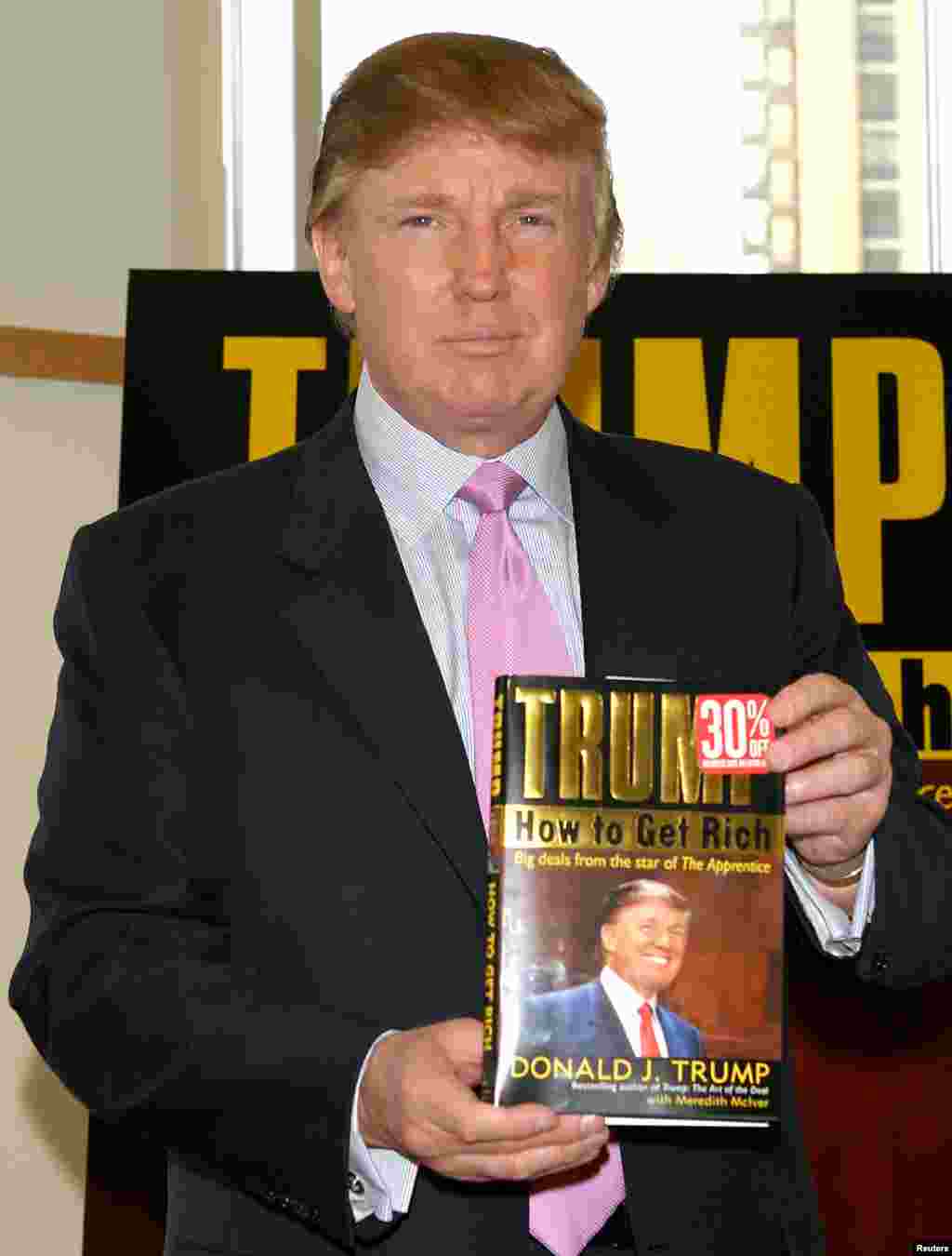Трамп держит в руках копию своей книги "Как стать богатым", 2004 год. Его книга "Искусство сделки", написанная в 1987 году, также бестселлером и приумножила его славу