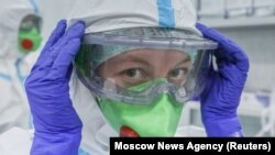 A medical specialist puts on personal protective equipment in Moscow's RZD-Medicine Central Clinical Hospital, which treats coronavirus patients. 