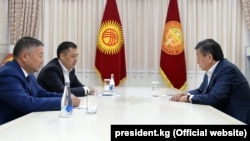 President Sooronbai Jeenbekov (right) meets with Kyrgyzstan's new parliamentary speaker, Kanat Isaev (front left), and prime minister, Sadyr Japarov, in Bishkek on October 14, 2020.
