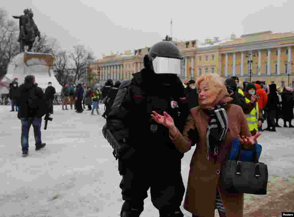 With a statue of Peter the Great in the background, riot police in St. Petersburg detain a woman on the city's Senate Square, the historic site of an 1825 revolt against Tsar Nicholas I. 